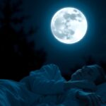 Nő alszik a telihold alatt, mely hatással van az alvásra.